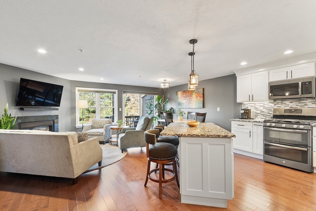 7 Green Briar Road, Unit 7 Fitchburg, MA 01420 - Photo 8 of 34 a living room with stainless steel appliances granite countertop furniture wooden floor and a view of kitchen