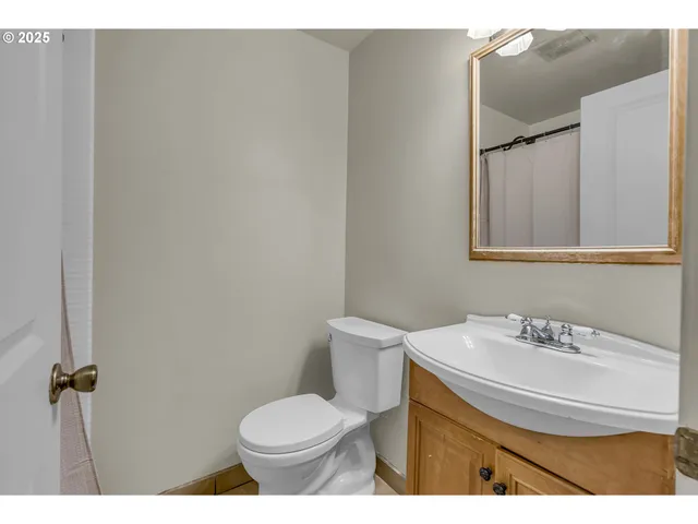 a bathroom with a sink toilet and a mirror