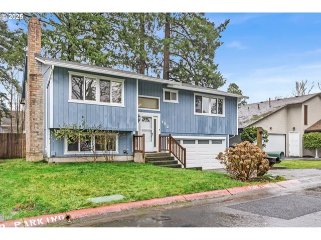 a front view of a house with a yard and a garage