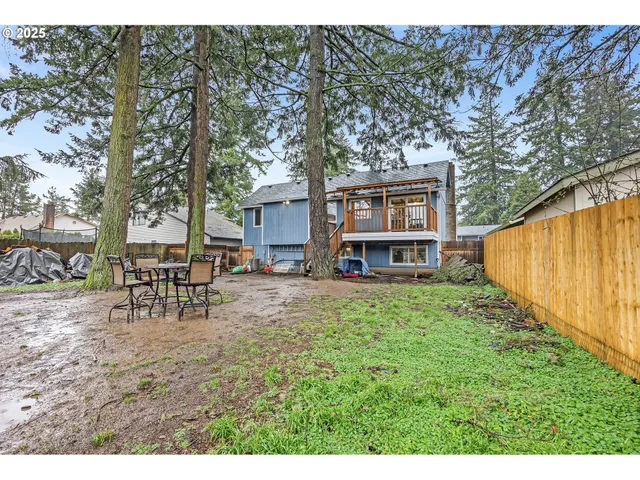 a view of a house with backyard and sitting area