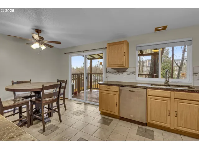 a open kitchen with a sink dining table and chairs
