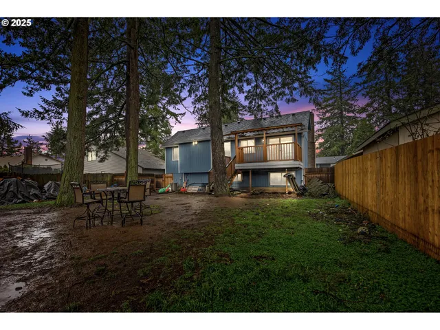a view of backyard with table and chairs and potted plants
