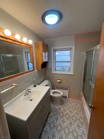 a bathroom with a sink a toilet and mirror