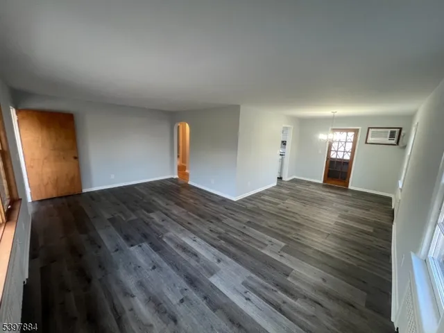 a view of a room with wooden floor