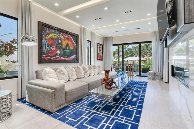 a kitchen with stainless steel appliances kitchen island granite countertop a table chairs sink and cabinets