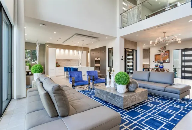 a kitchen with kitchen island a large counter top space a sink stainless steel appliances and cabinets