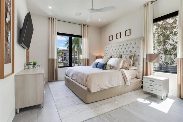 a bedroom with a large bed and a large window