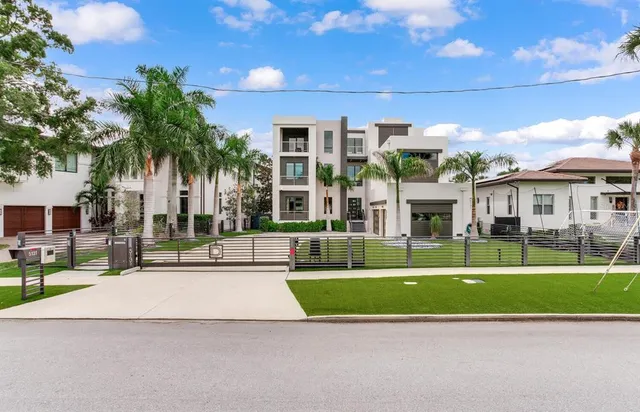 a front view of a multi story building with yard