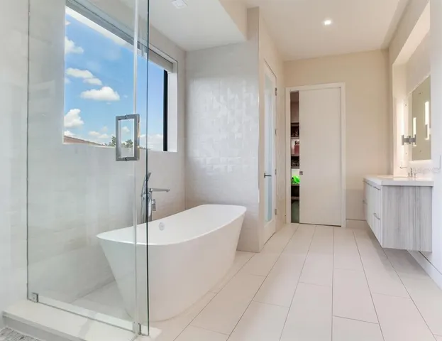 a bedroom with a large bed and a large window