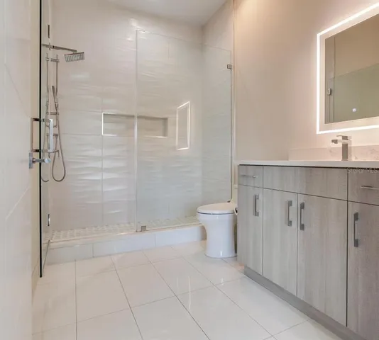 a large bed sitting in a bedroom and a flat tv screen