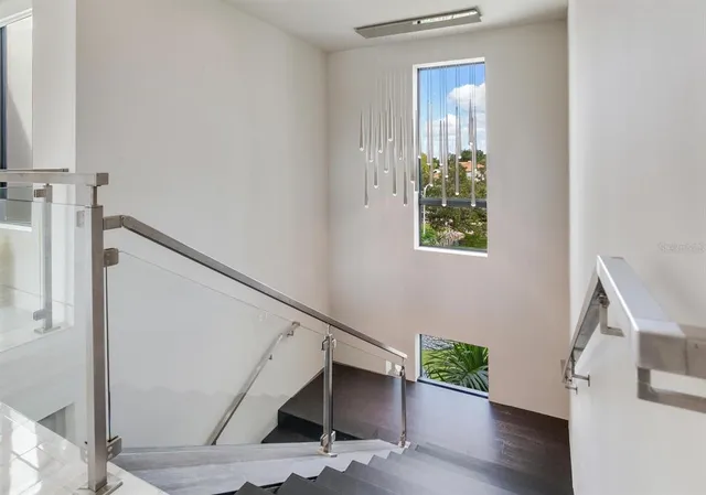 a view of a patio with a dining table and chairs with the view of small garden