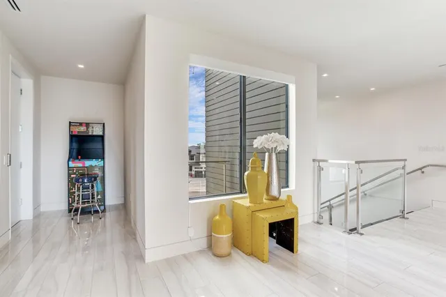 a view of a lake with a table and chairs under an umbrella