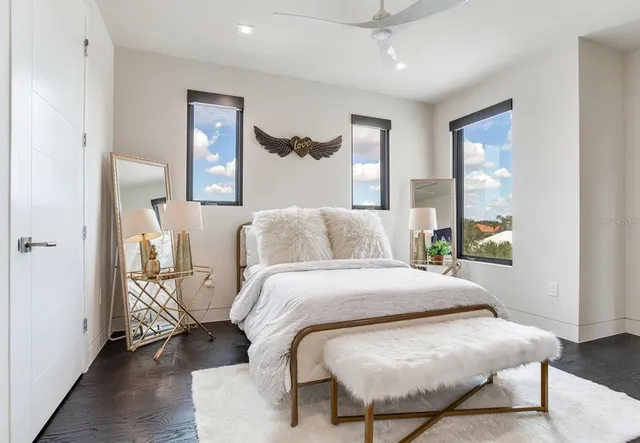 an aerial view of a house with a garden and lake view