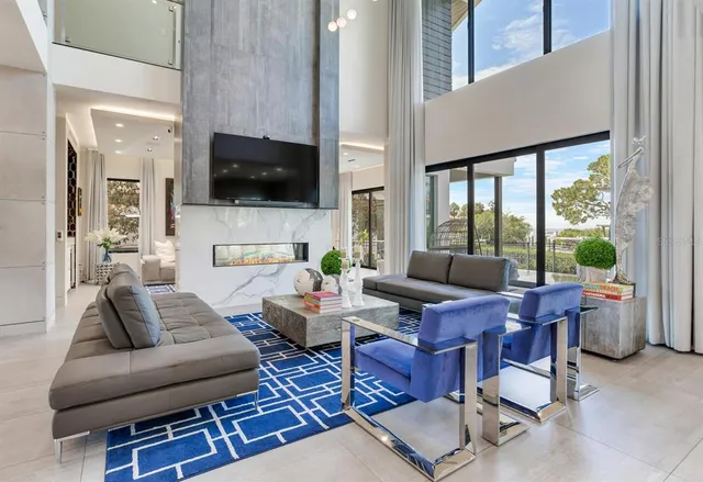 a dining room with furniture a chandelier and a rug
