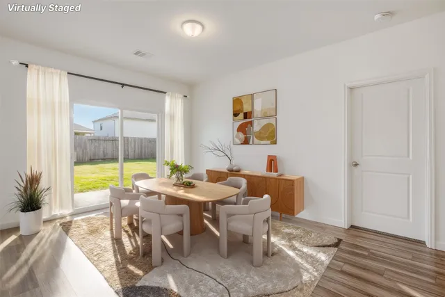 a living room with furniture a window and a potted plant