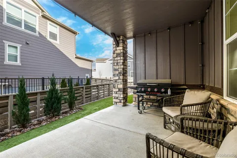 a view of a house with backyard porch and sitting area