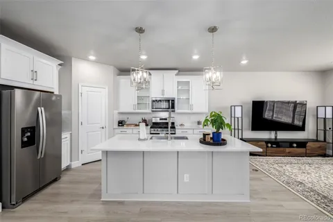 a kitchen with stainless steel appliances a sink stove and microwave