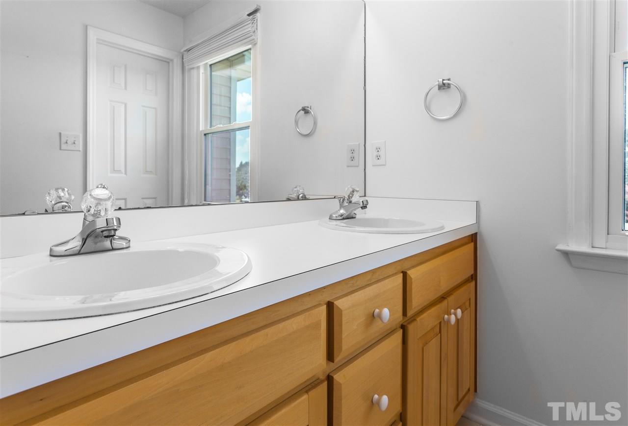 1017 Brack Place Raleigh, NC 27603 - Photo 14 of 24 a bathroom with a sink and a mirror