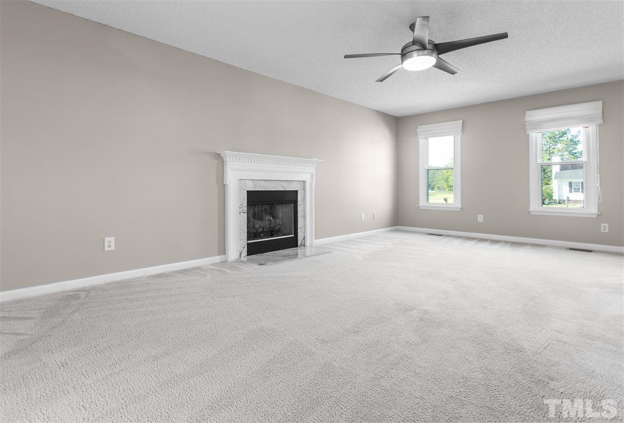 1017 Brack Place Raleigh, NC 27603 - Photo 7 of 24 an empty room with windows and fireplace