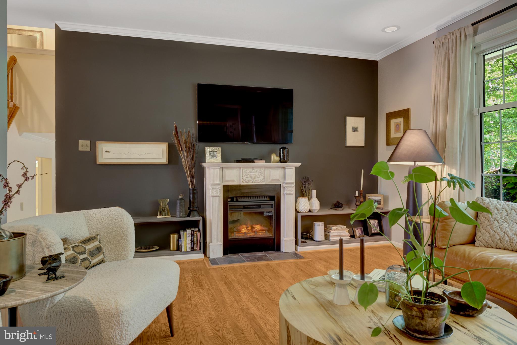 9001 Streamview Lane Vienna, VA 22182 - Photo 13 of 64 a living room with furniture a flat screen tv and a fireplace
