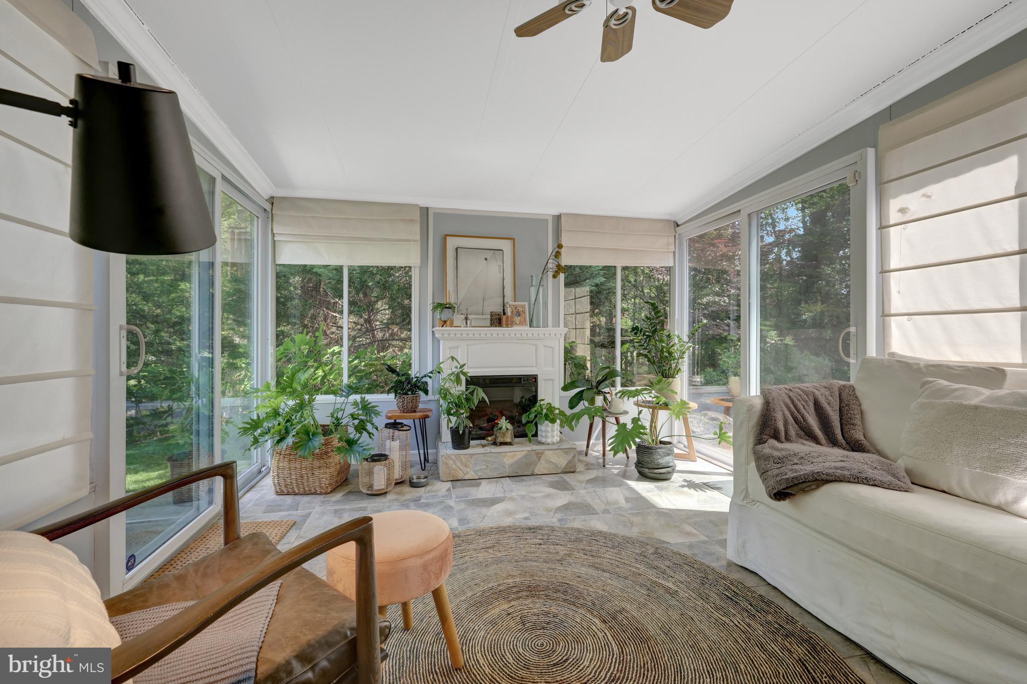 9001 Streamview Lane Vienna, VA 22182 - Photo 25 of 64 a living room with furniture potted plant and a large window