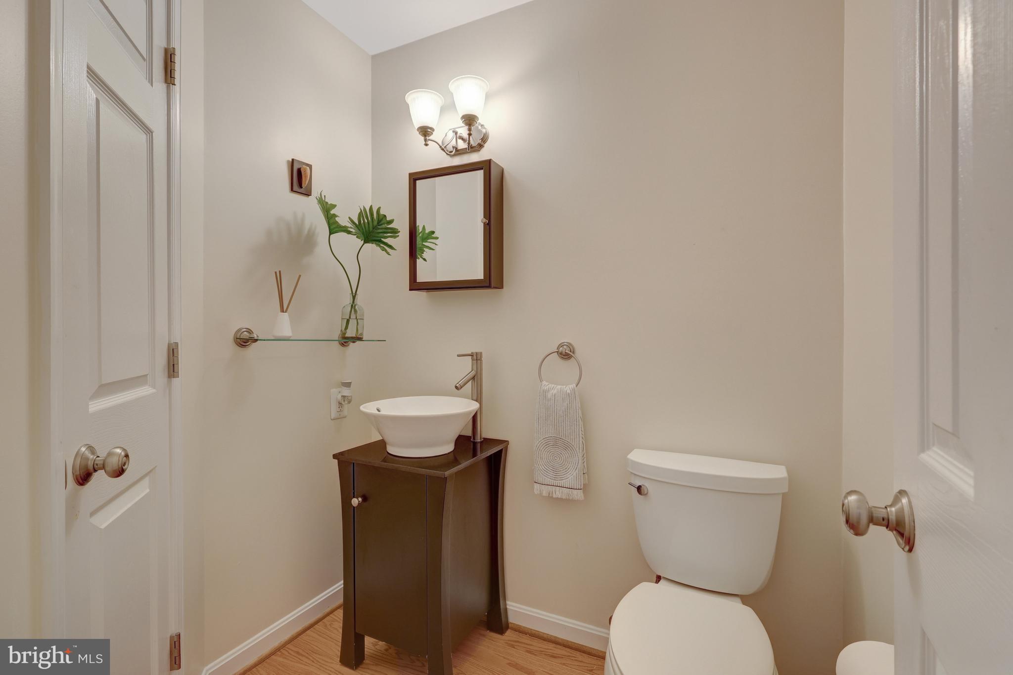 9001 Streamview Lane Vienna, VA 22182 - Photo 28 of 64 a bathroom with a toilet sink and mirror