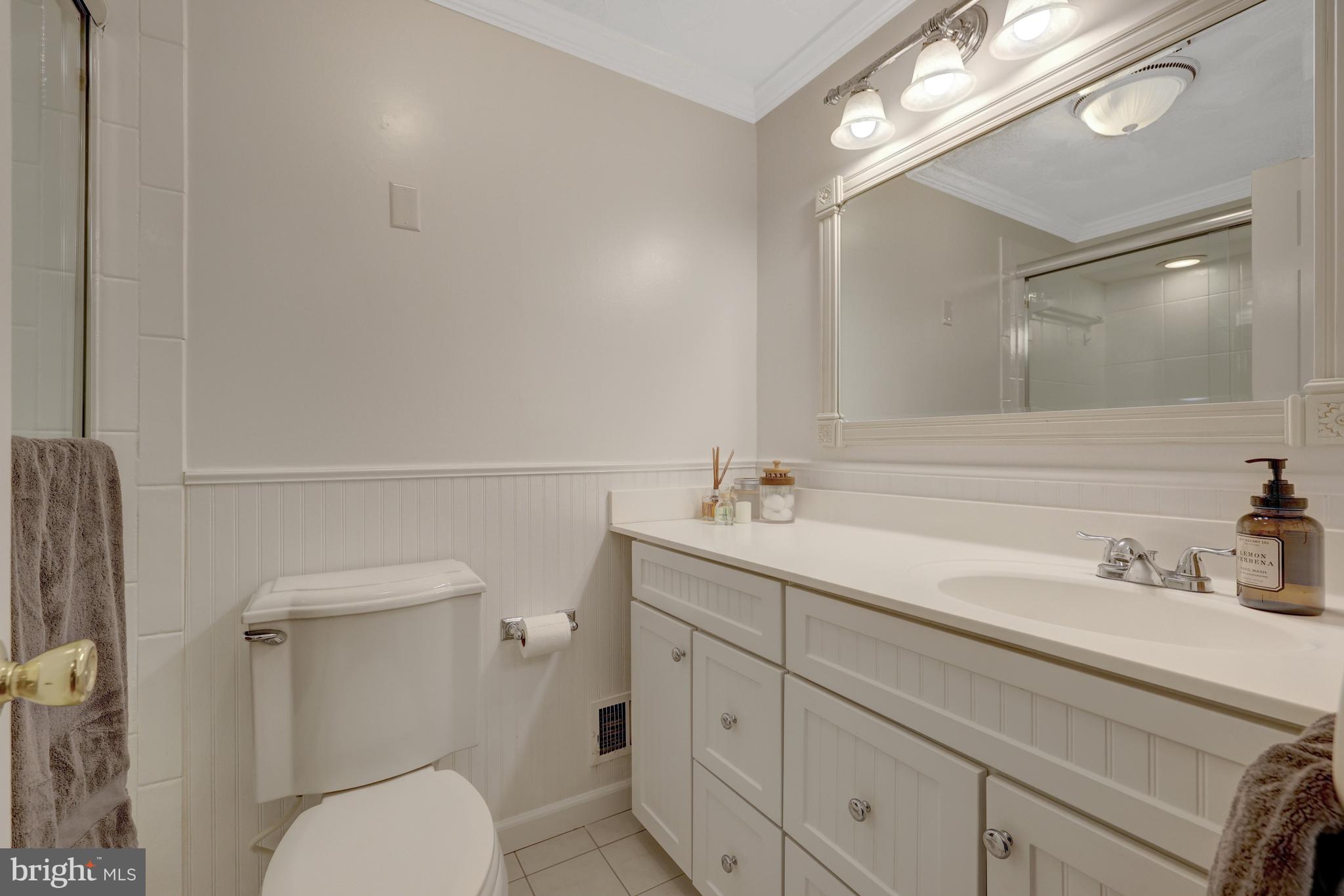 9001 Streamview Lane Vienna, VA 22182 - Photo 35 of 64 a bathroom with a toilet a sink a mirror and vanity