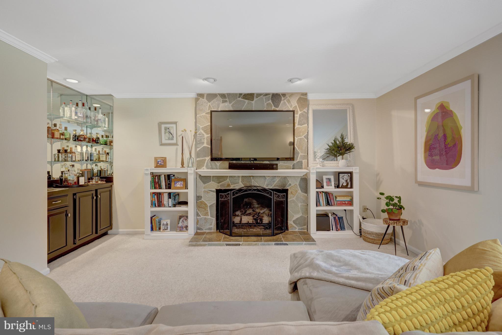 9001 Streamview Lane Vienna, VA 22182 - Photo 43 of 64 a living room with furniture and a fireplace