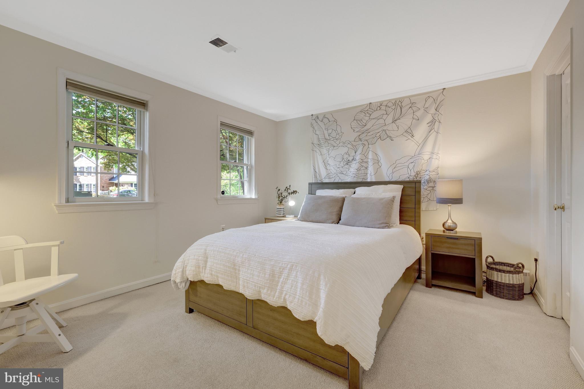 9001 Streamview Lane Vienna, VA 22182 - Photo 49 of 64 a bedroom with a bed and a night stand