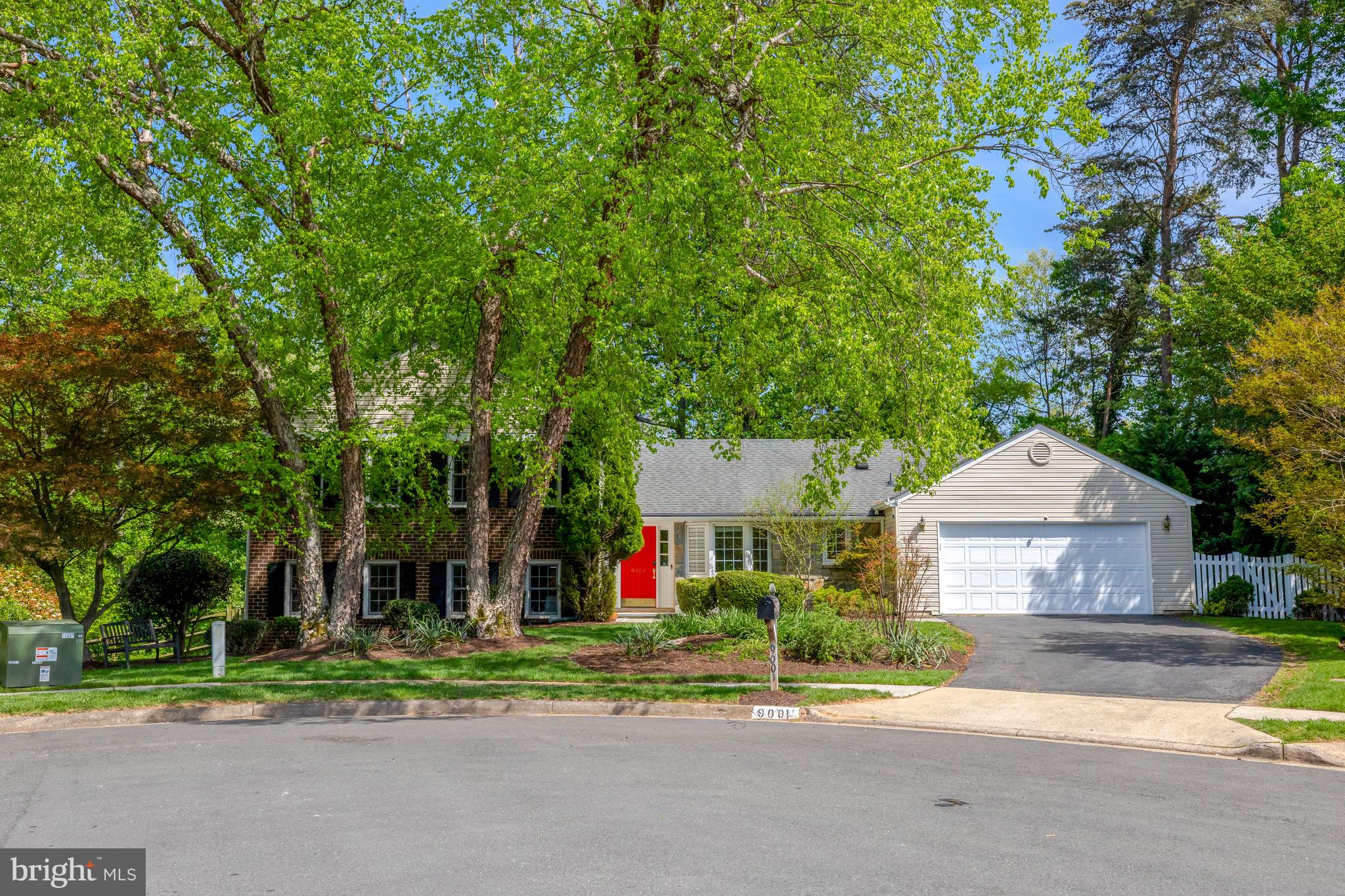 9001 Streamview Lane Vienna, VA 22182 - Photo 6 of 64 a front view of a house with a yard and trees