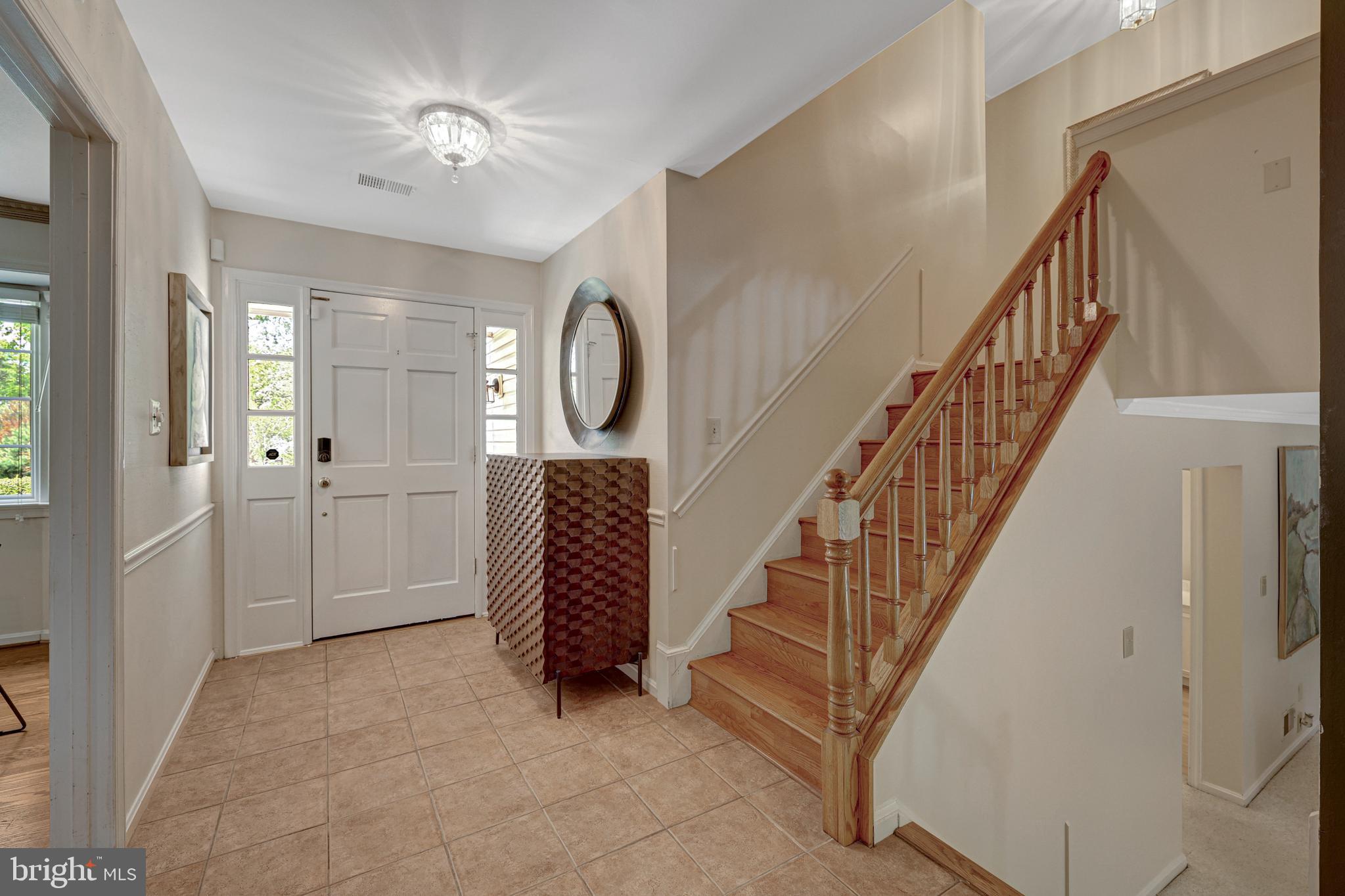 9001 Streamview Lane Vienna, VA 22182 - Photo 8 of 64 a view of a hallway with entryway closet and hall with wooden floor