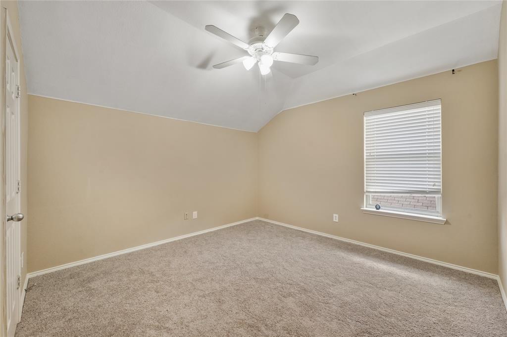 2003 Diamondback Forney, TX 75126 - Photo 22 of 30 Empty room with light colored carpet, lofted ceiling, a wealth of natural light, and ceiling fan