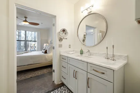 a en suite bathroom with a double vanity sink and a mirror