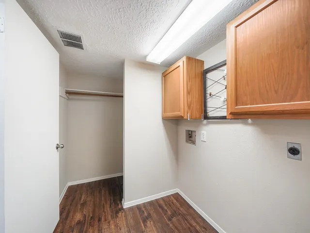 a view of a room with wooden floor and window