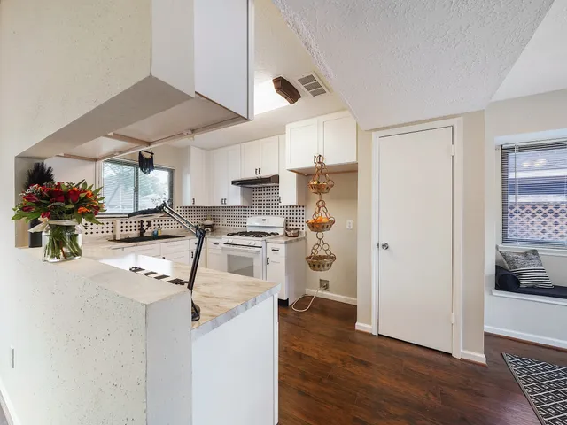 a kitchen with stainless steel appliances a stove a sink and a refrigerator