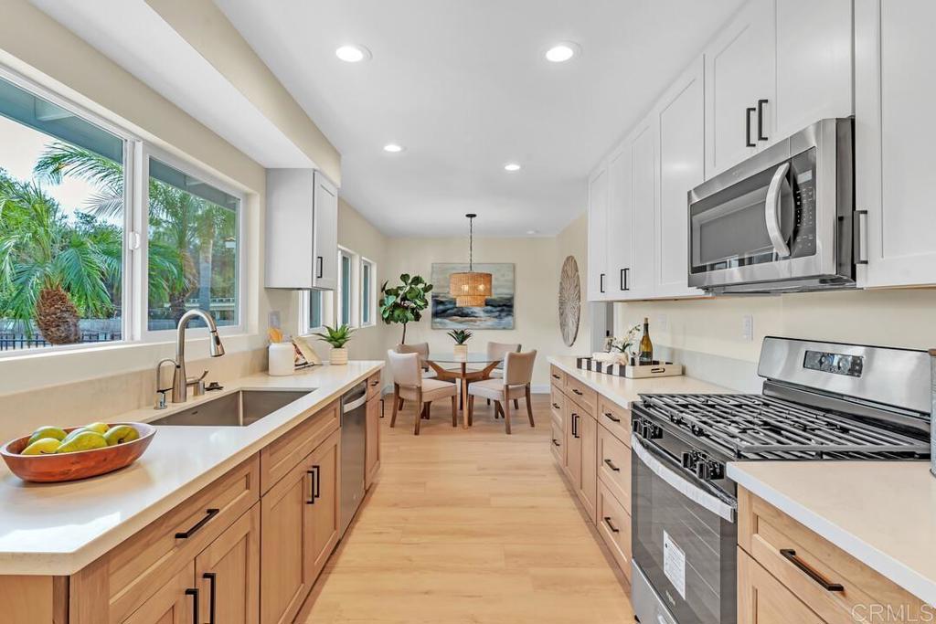 1165 Oak Drive Vista, CA 92084 - Photo 22 of 33 a large kitchen with stainless steel appliances granite countertop a lot of counter space and a sink