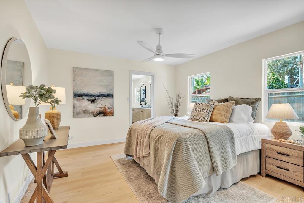 1165 Oak Drive Vista, CA 92084 - Photo 7 of 33 a spacious bedroom with a bed and a chandelier