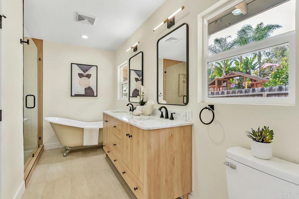 1165 Oak Drive Vista, CA 92084 - Photo 8 of 33 a bathroom with a sink mirror and a toilet