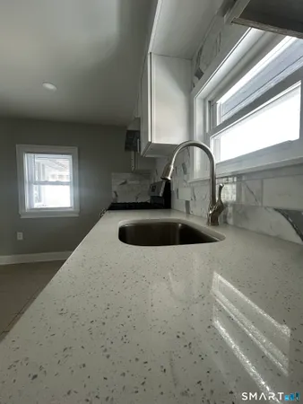 a kitchen with a sink cabinets and a window