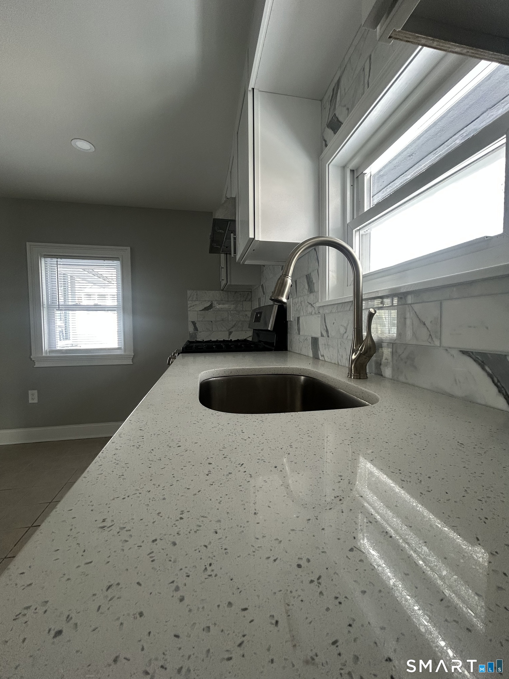 54 Forest Street, Unit 2 Torrington, CT 06790 - Photo 11 of 36 a kitchen with a sink cabinets and a window