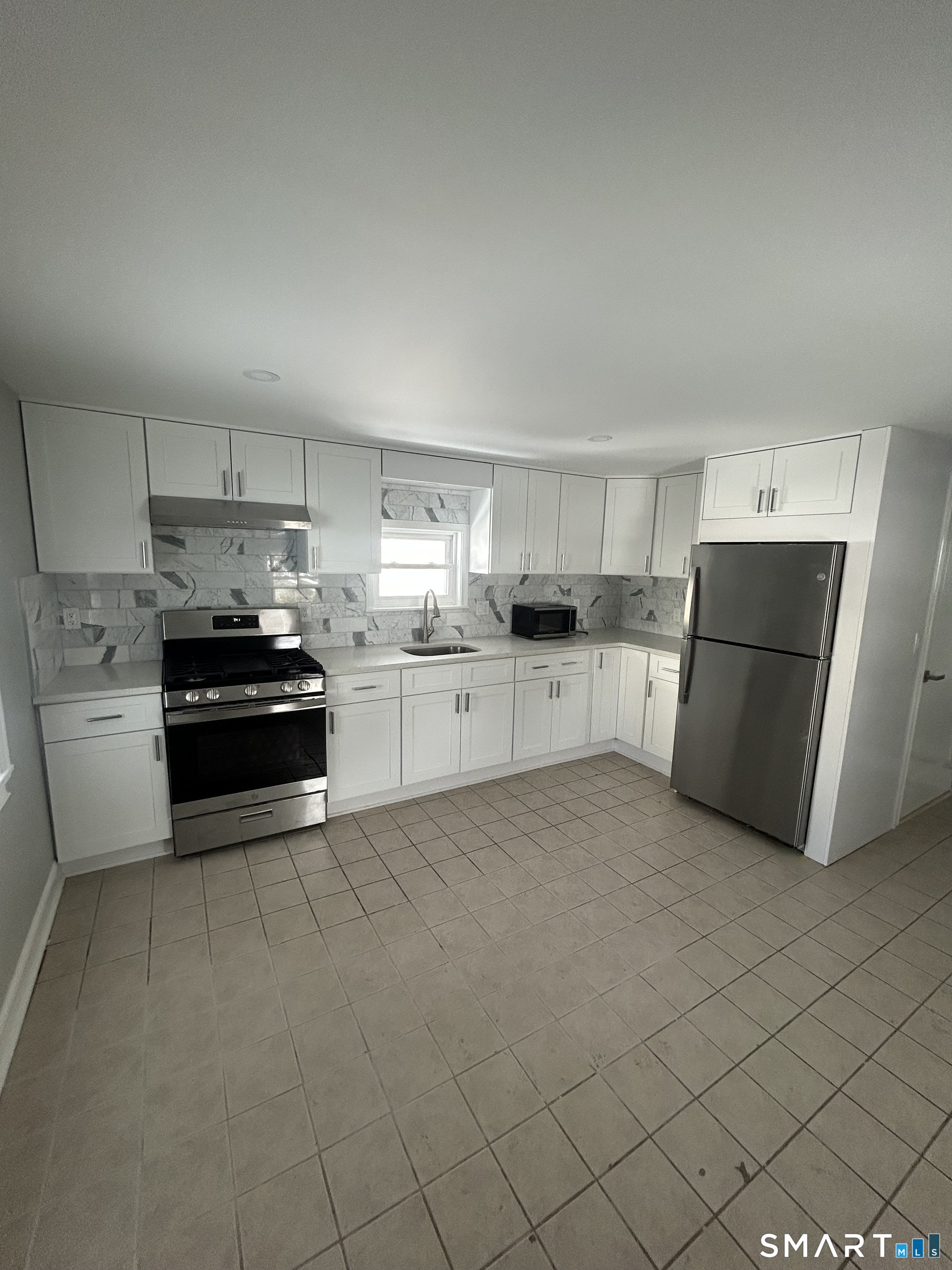 54 Forest Street, Unit 2 Torrington, CT 06790 - Photo 15 of 36 a kitchen with a refrigerator and a stove