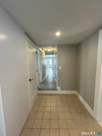 a bathroom with a granite countertop sink mirror bathtub and next to a window