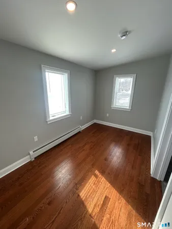 a view of a room with wooden floor