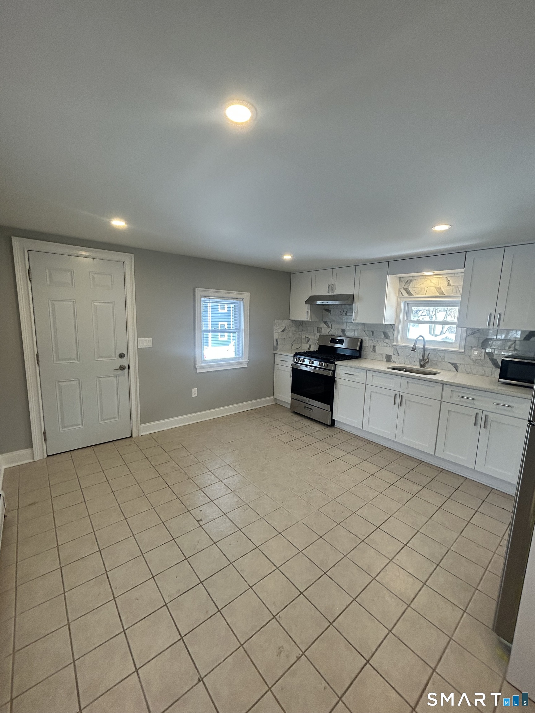 54 Forest Street, Unit 2 Torrington, CT 06790 - Photo 6 of 36 a view of kitchen with granite countertop cabinets and window