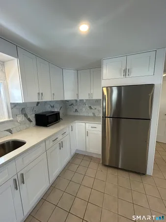 a kitchen with a refrigerator a sink and cabinets
