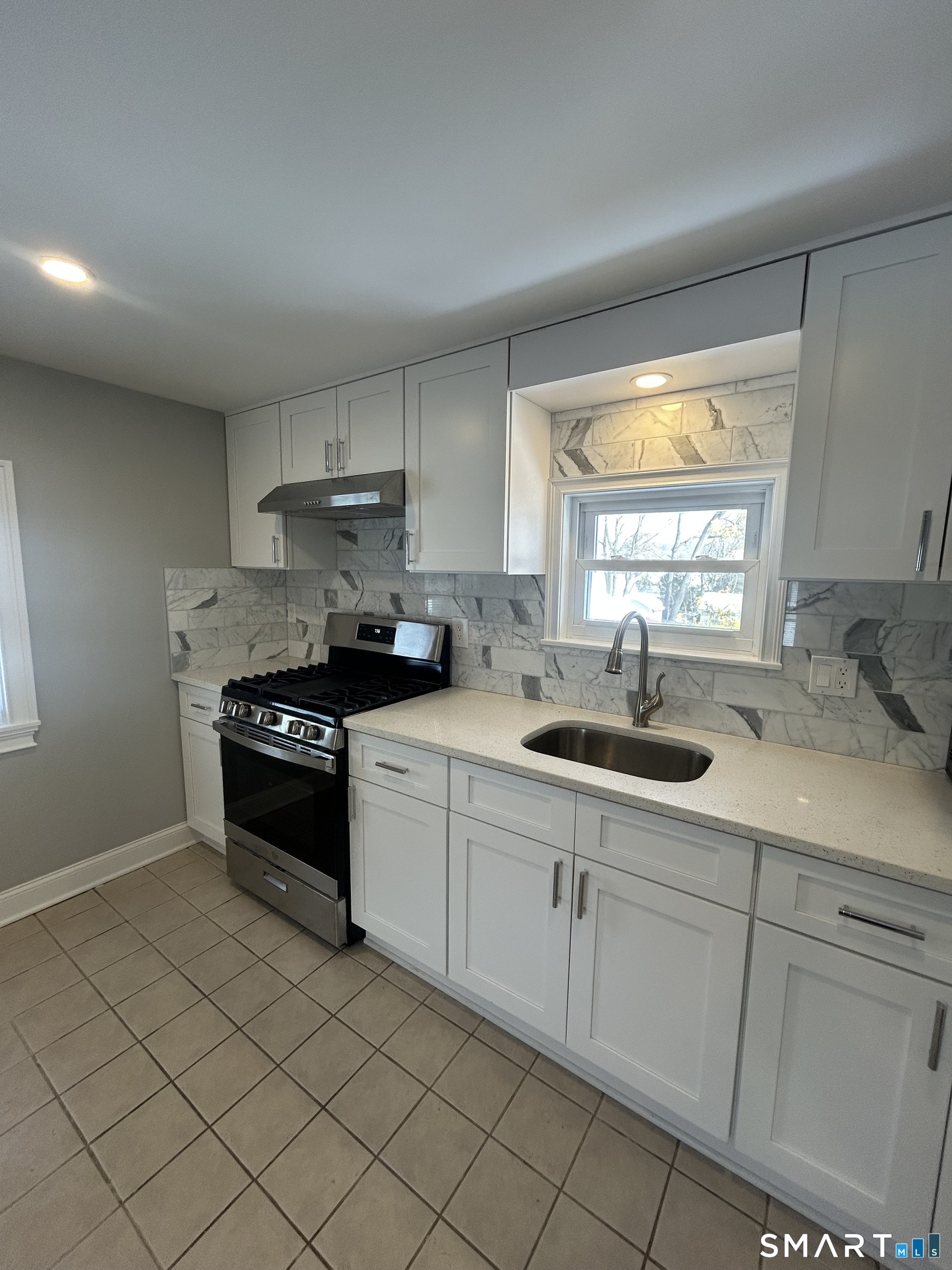 54 Forest Street, Unit 2 Torrington, CT 06790 - Photo 8 of 36 a kitchen with stainless steel appliances granite countertop a sink and a stove