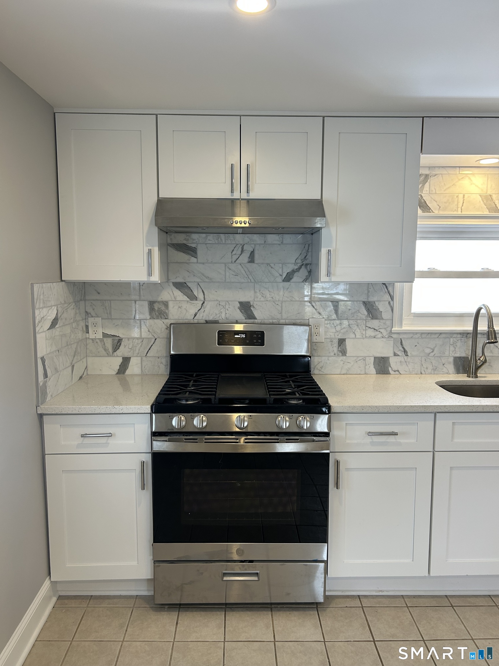 54 Forest Street, Unit 2 Torrington, CT 06790 - Photo 9 of 36 a stove top oven sitting inside of a kitchen