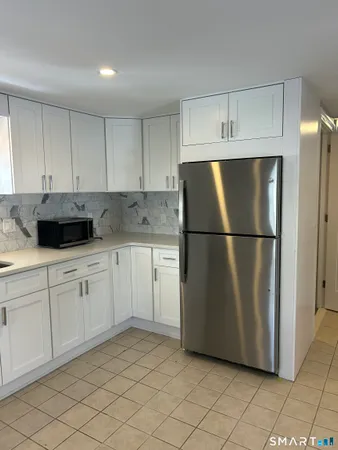 a kitchen with cabinets and stainless steel appliances