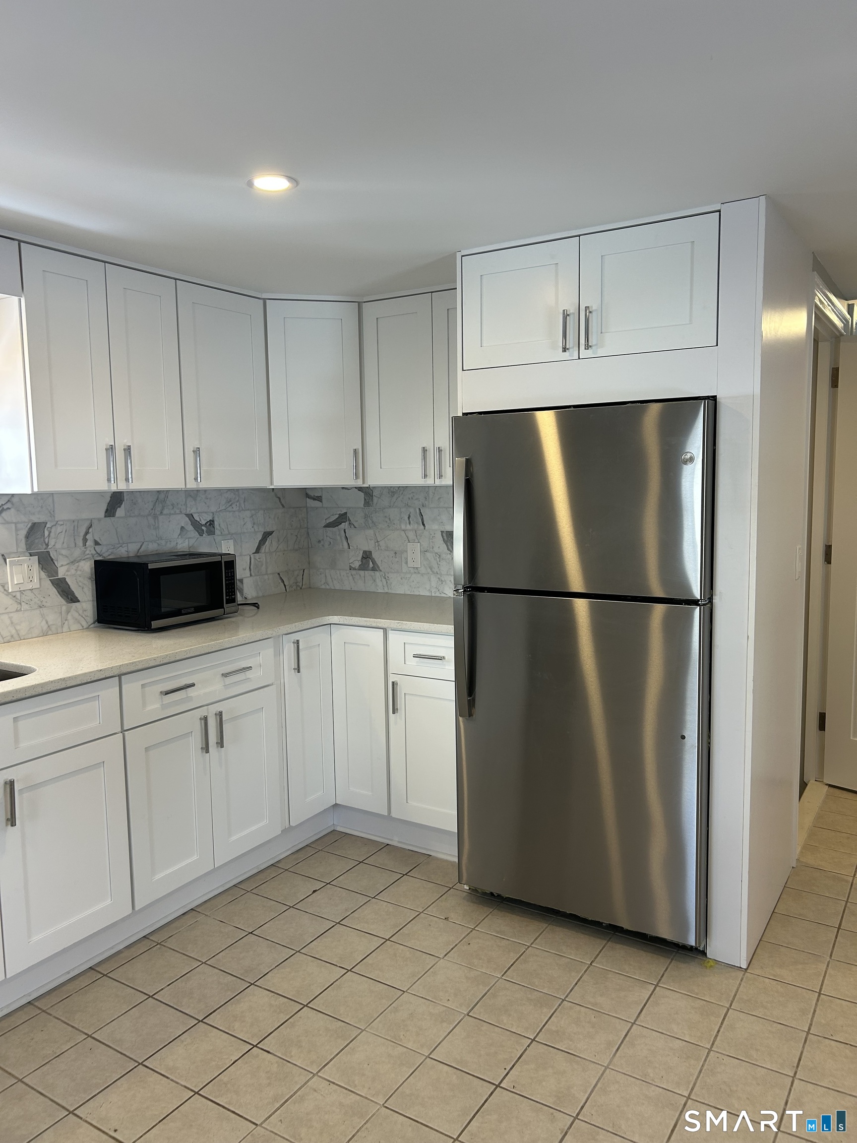 54 Forest Street, Unit 2 Torrington, CT 06790 - Photo 10 of 36 a kitchen with cabinets and stainless steel appliances