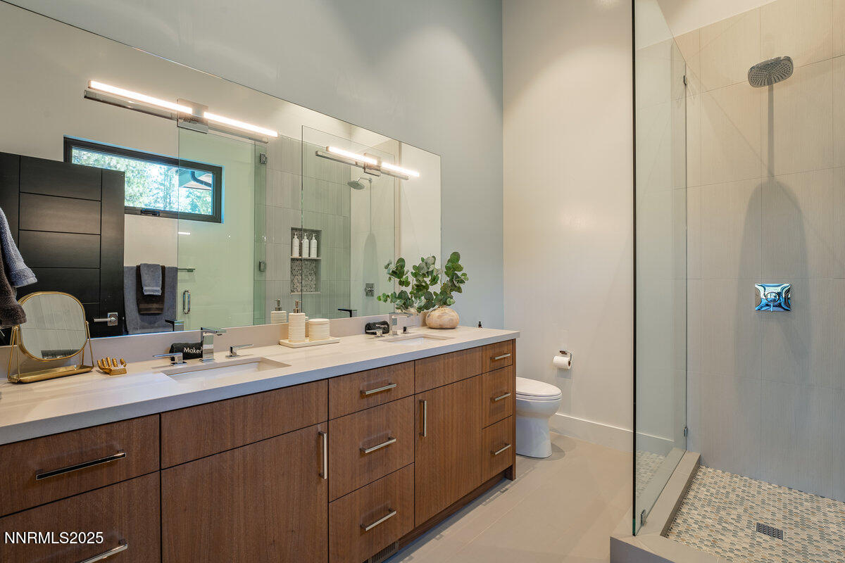 181 Redding Way Carson City, NV 89705 - Photo 26 of 40 a bathroom with a double vanity sink toilet and mirror